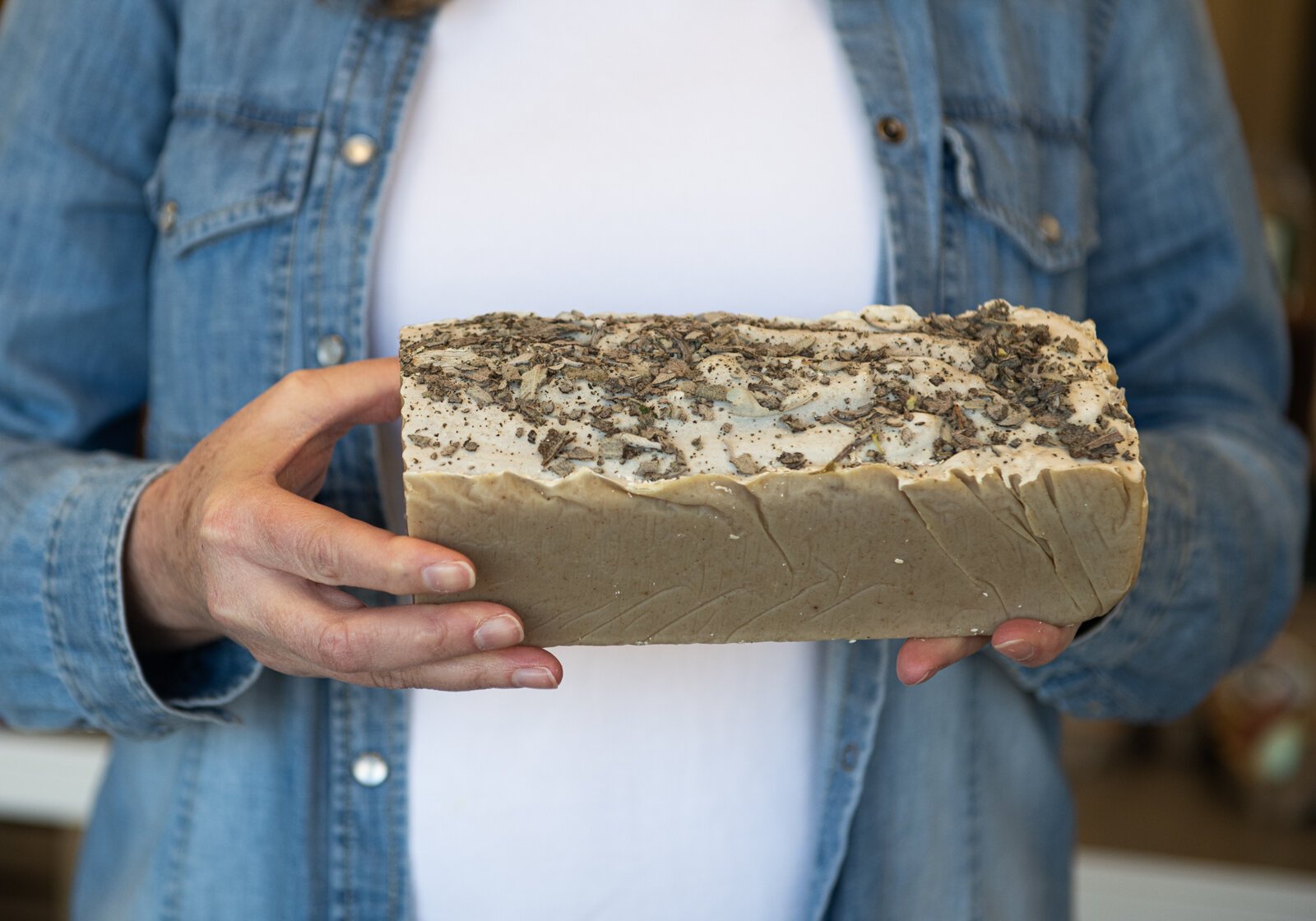 Heather Eracleous, owner of Vessell Refillery FW, holds a blueberry sage soap loaf she gets from a local supplier.