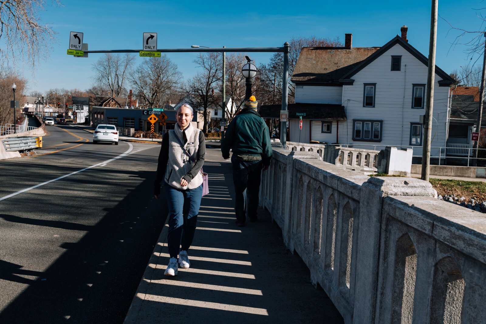 Mike Roeger and Rachel Jones pass each other on the bridge on Saint Joe Boulevard, showcasing how small the sidewalk is.