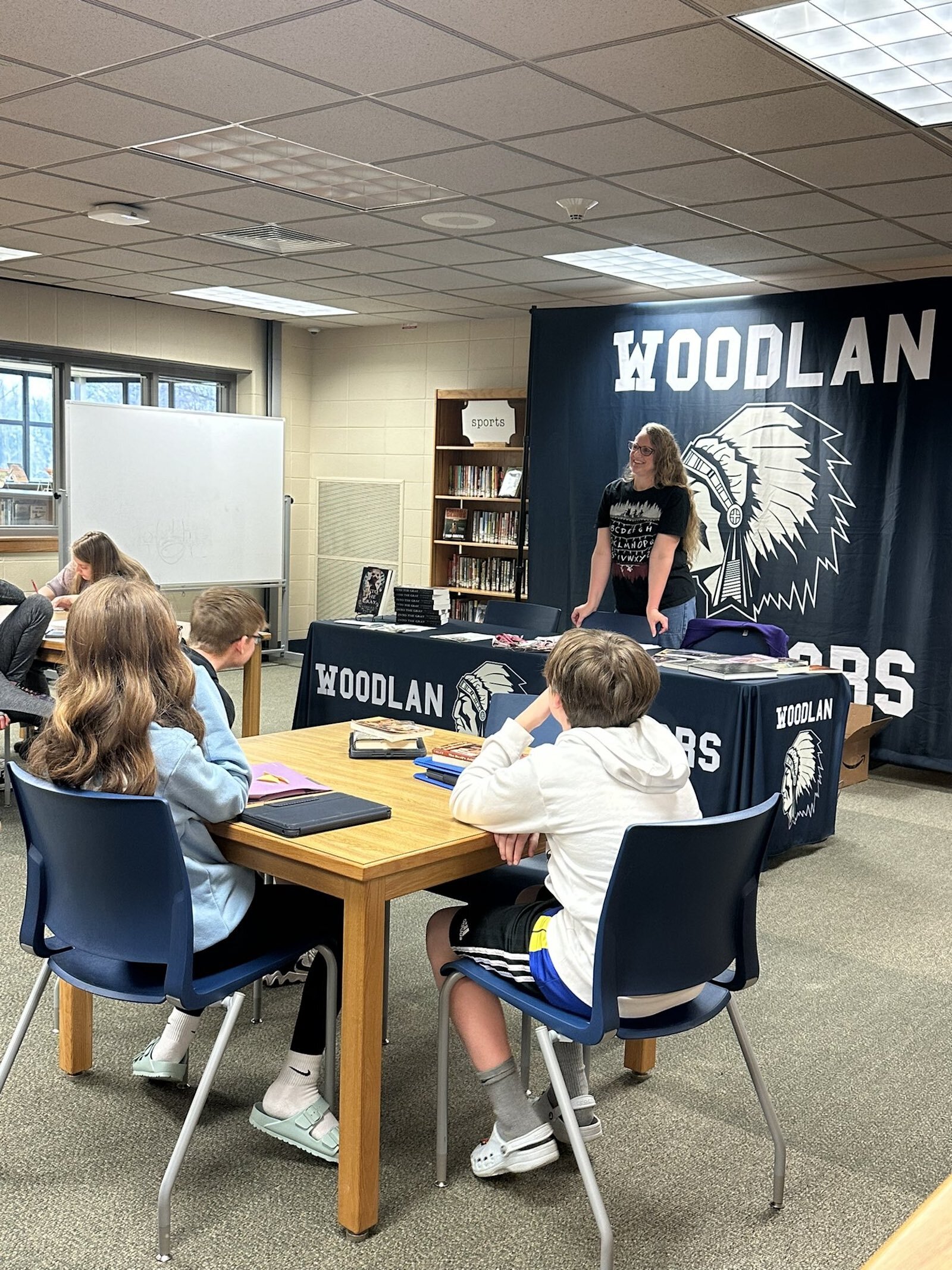 Kathleen Palm speaks with students at Woodland Junior High School.