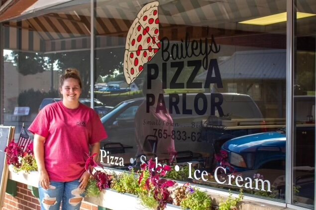 Bailey Sewell outside of her restaurant, Bailey's Pizza Parlor.