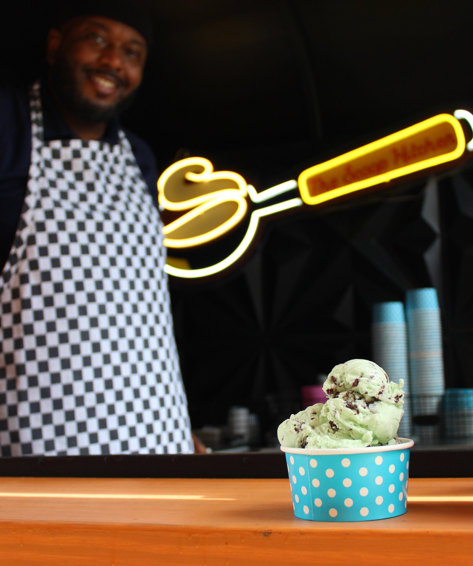 Tony Belton, owner of Classic City Creamery and the Kitchen Scoopery, serves up a bowl of chocolate chip mint ice cream.