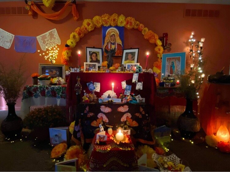 An ofrenda to honor Breonna Taylor illuminated with light.