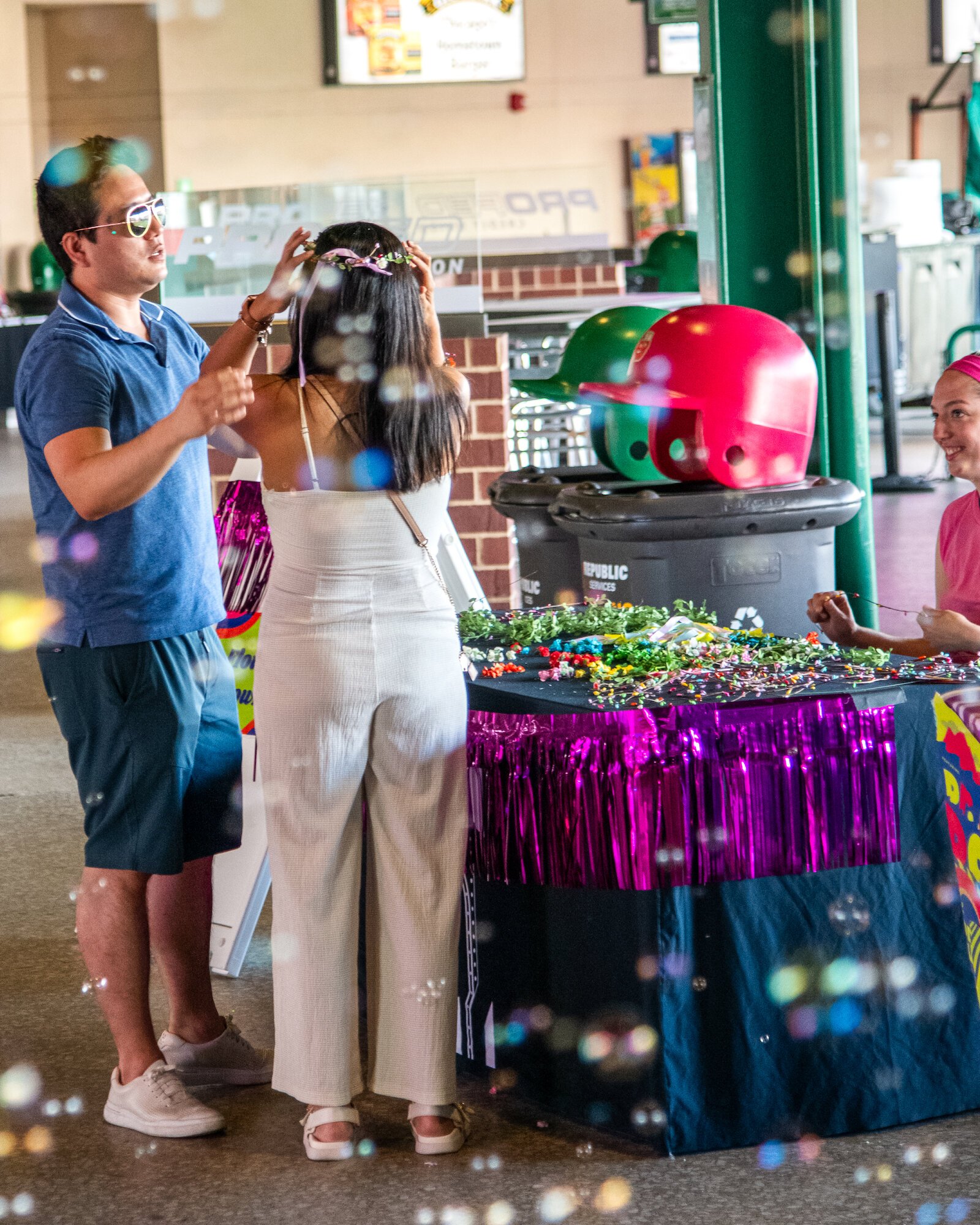 Festival goers explore vendors along the concourse at Parkview Field.