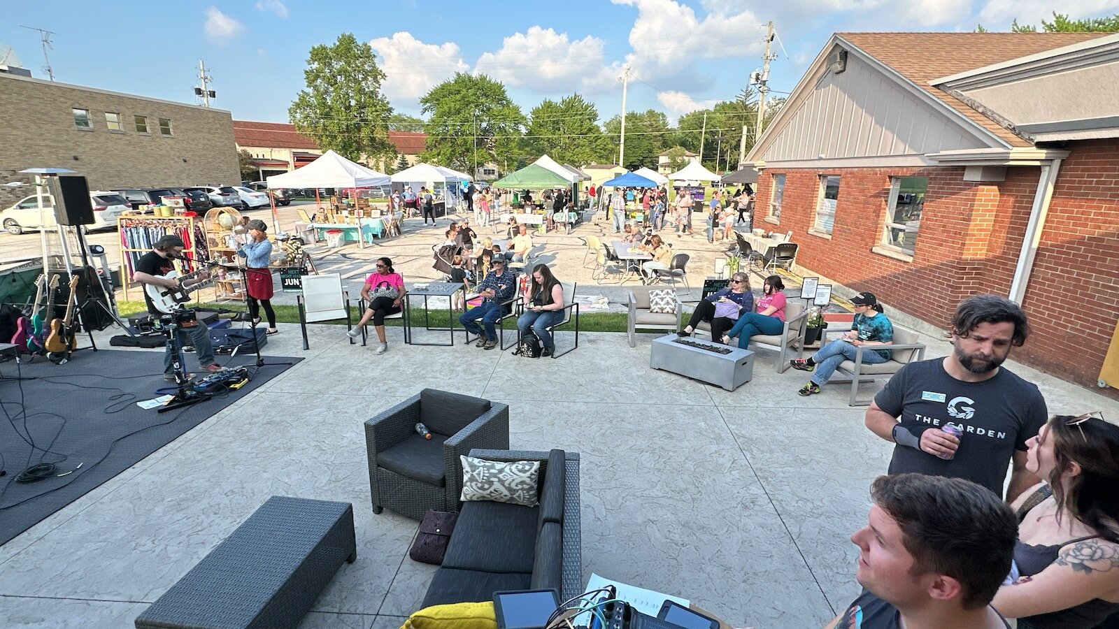 Visitors at the market stop to enjoy live music