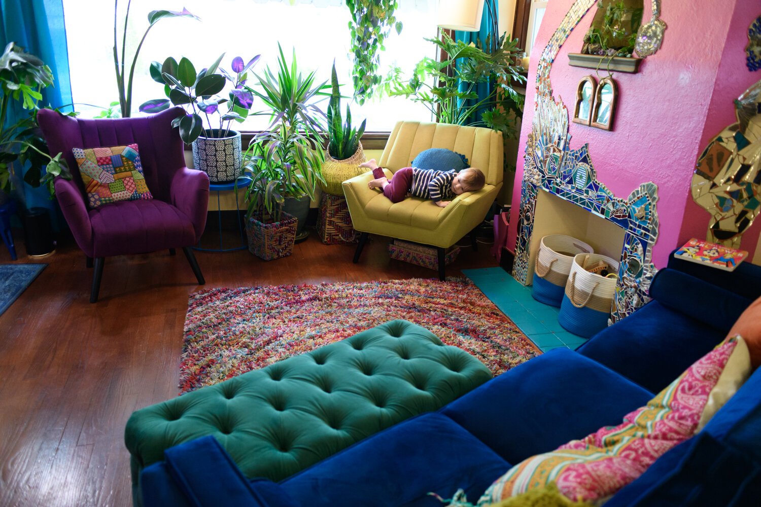 The living room is filled with lots of color and plants.