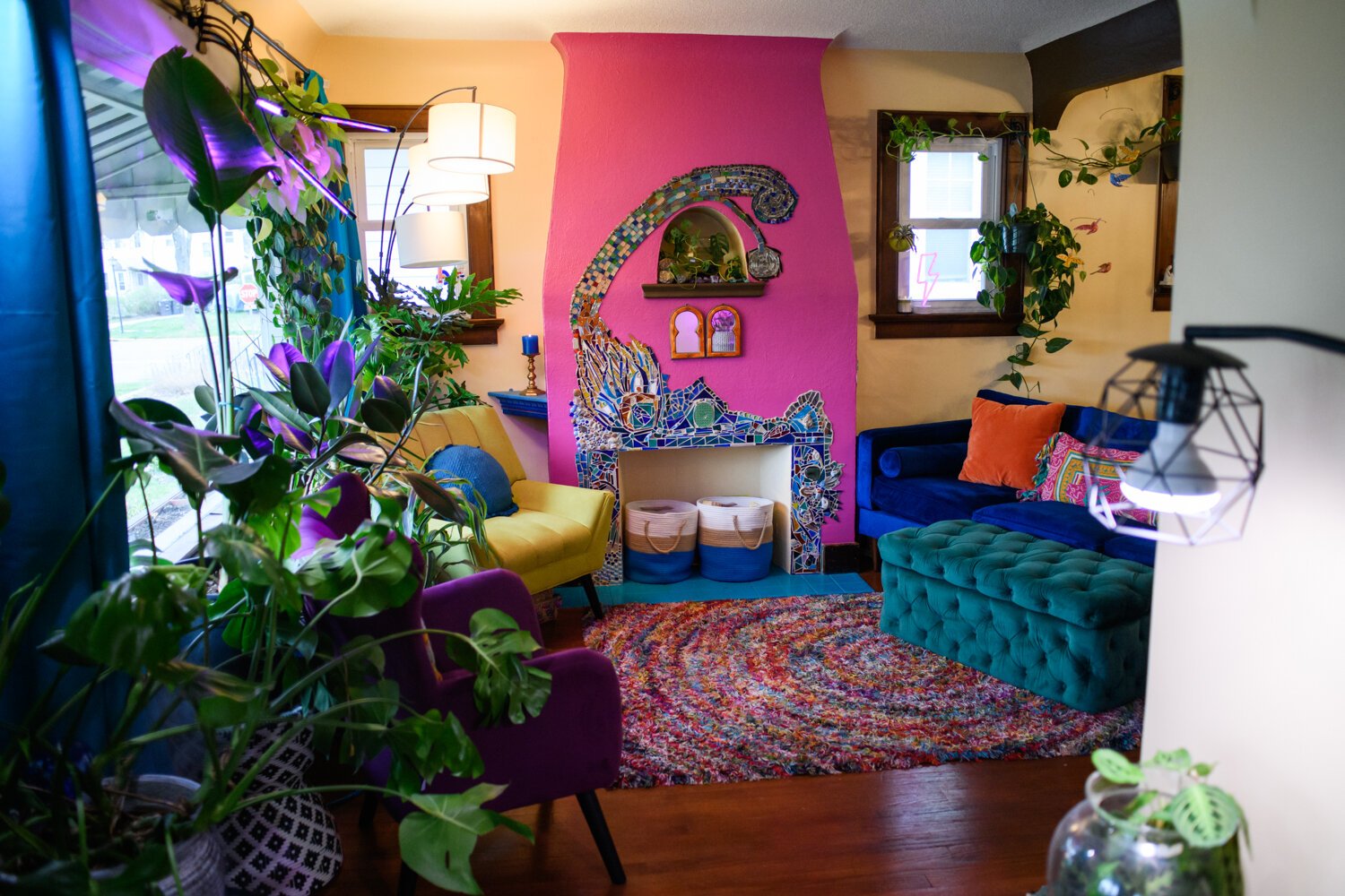 The view from the entry way includes plant and a colorful fireplace into the living room at the Porter family home.