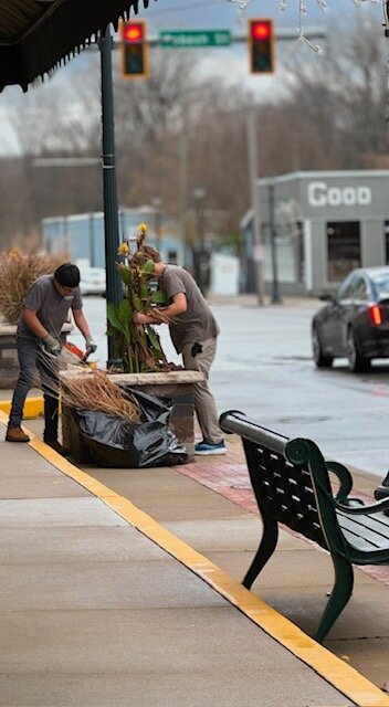 Teens in the Growing Teens for Life place arrangements in planters lining the streets of Wabash.