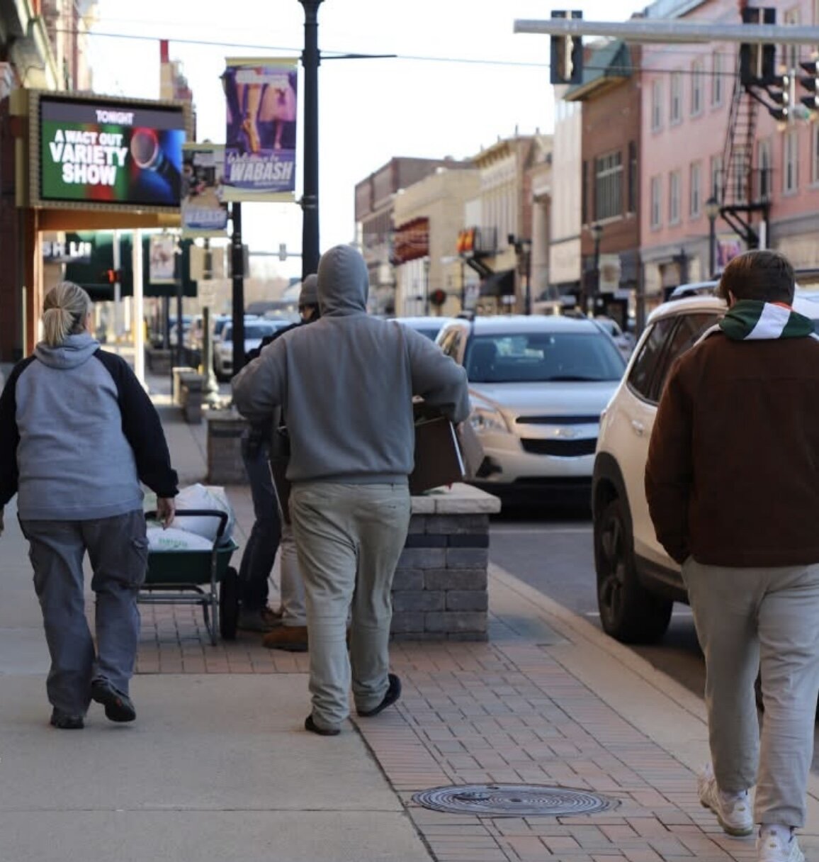 Teens in the Growing Teens for Life place arrangements in planters lining the streets of Wabash.