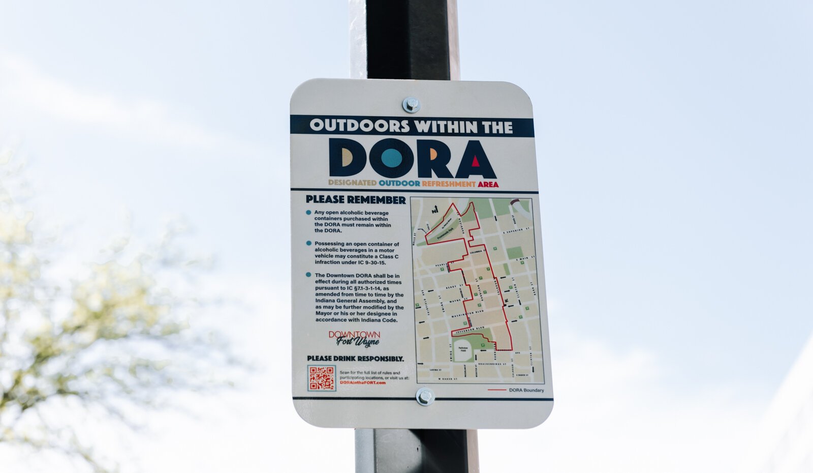 A sign at Washington Boulevard and Calhoun Street reminds people of the rules within the new Downtown DORA (Designated Outdoor Refreshment Area).