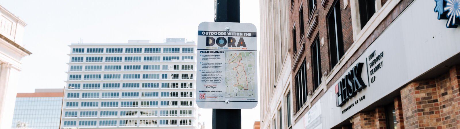A sign at Berry Street and Calhoun Street reminds people of the rules within the new Downtown DORA (Designated Outdoor Refreshment Area).
