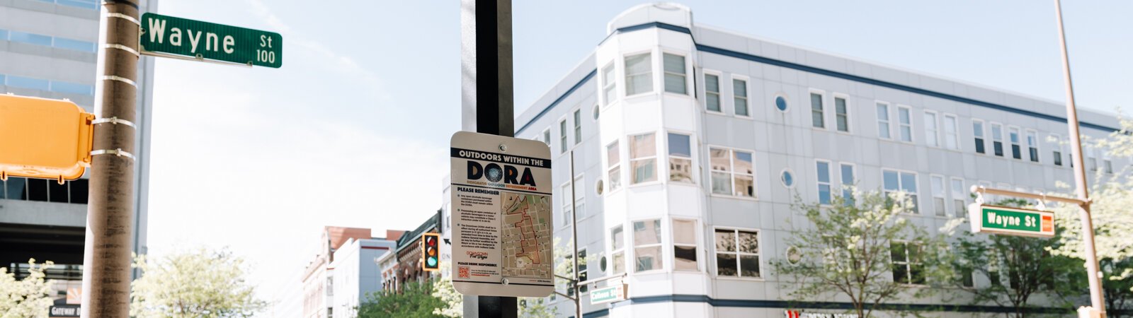 A sign at Wayne Street and Calhoun Street in downtown Fort Wayne reminds people of the rules within the new DORA (Designated Outdoor Refreshment Area).