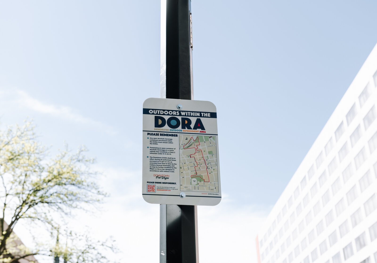 A sign at Washington Boulevard and Calhoun Street reminds people of the rules within the new Downtown DORA (Designated Outdoor Refreshment Area).