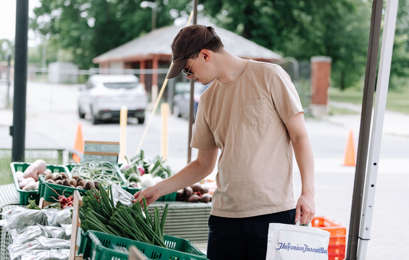 Nathan Skinner looks at produce at the Berry Hill Farm booth during the Fort Wayne's Farmers Market.