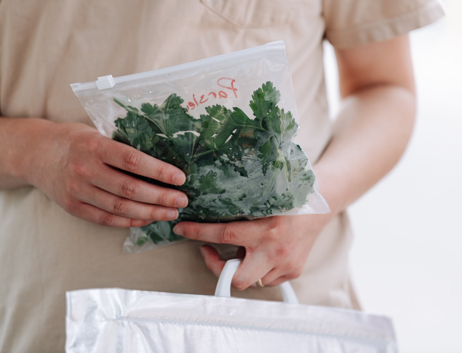 Nathan Skinner holds a bag of parsley at the Berry Hill Farm booth during the Fort Wayne's Farmers Market at Electric Works.