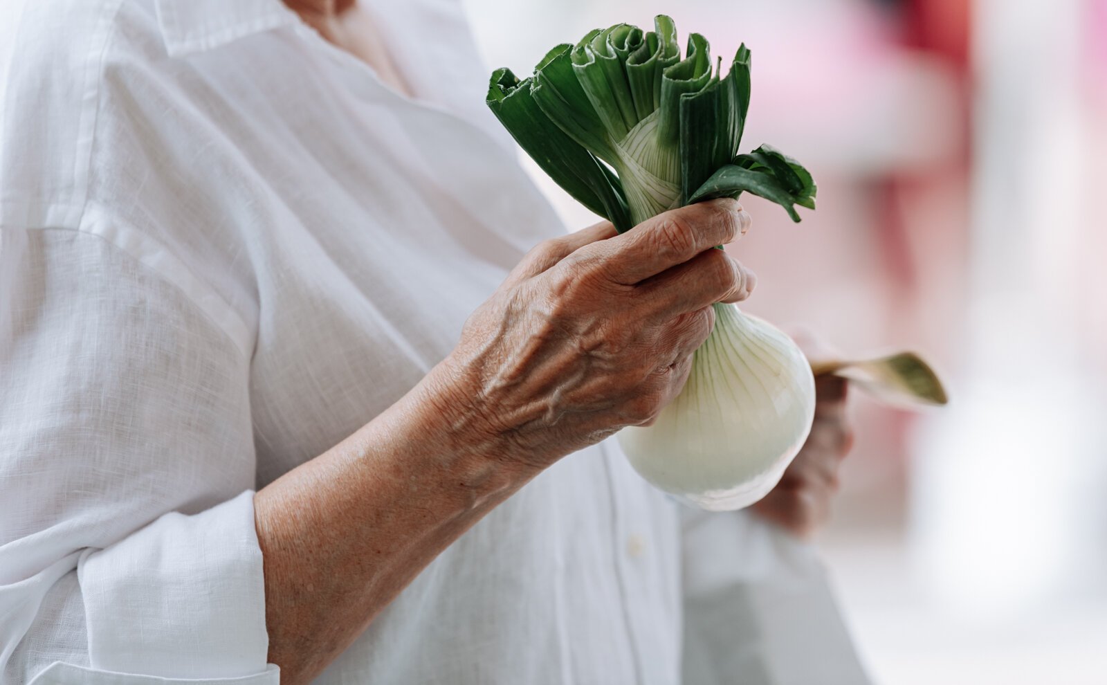 A customer picks out an onion at the Berry Hill Farm booth.