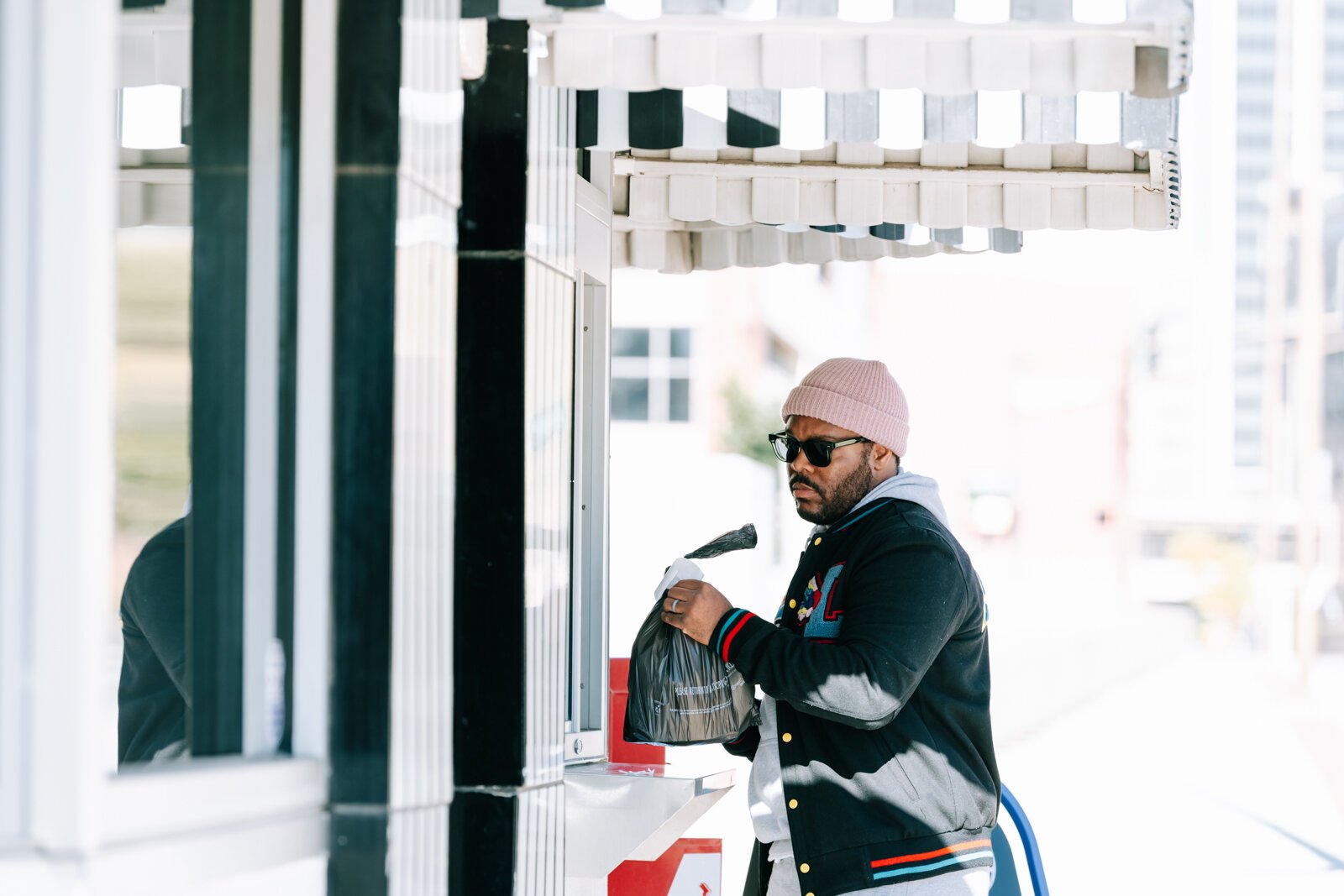 Chris Bush picks up his order from the walk-up window at Powers Hamburgers.