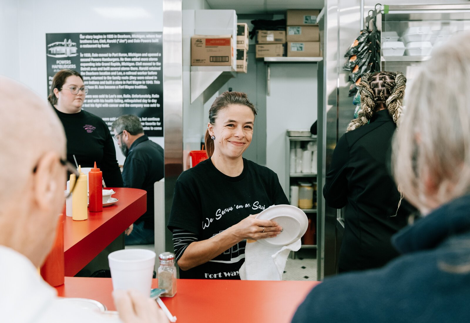 Ashley Jones dries off a plate at Powers Hamburgers.