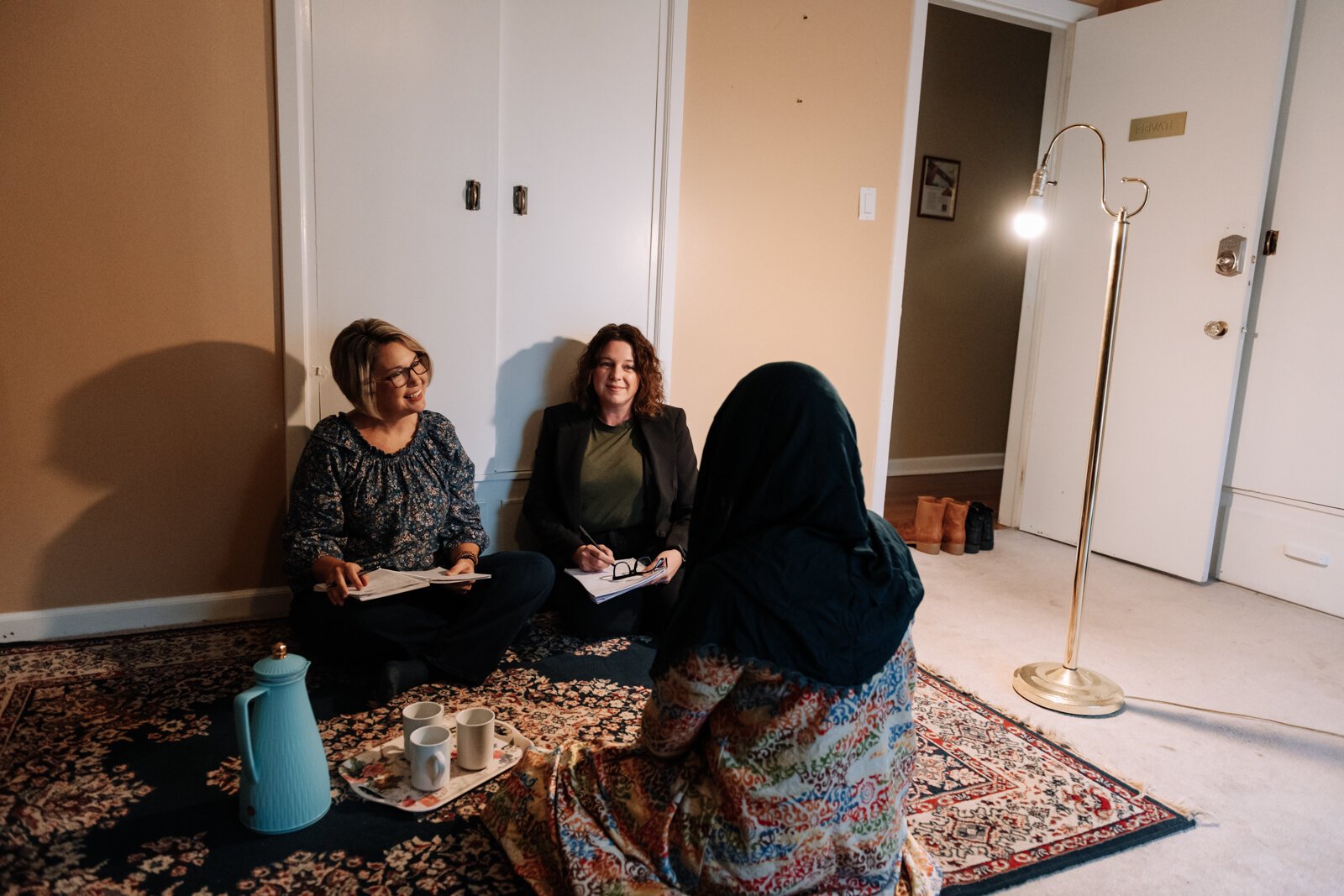 Heather Morris, director of outreach and operations, left, and Valisha Reber, medical and social services liaison demonstrate what a client in-home meeting would look like at the International House office in Fort Wayne.