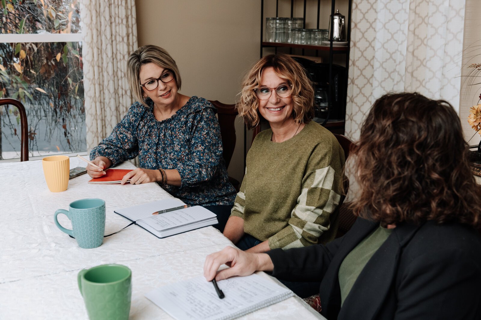  From left: Heather Morris, director of outreach and operations, Ann Heign, executive director, and Valisha Reber, medical and social services liaison chat during a staff meeting.