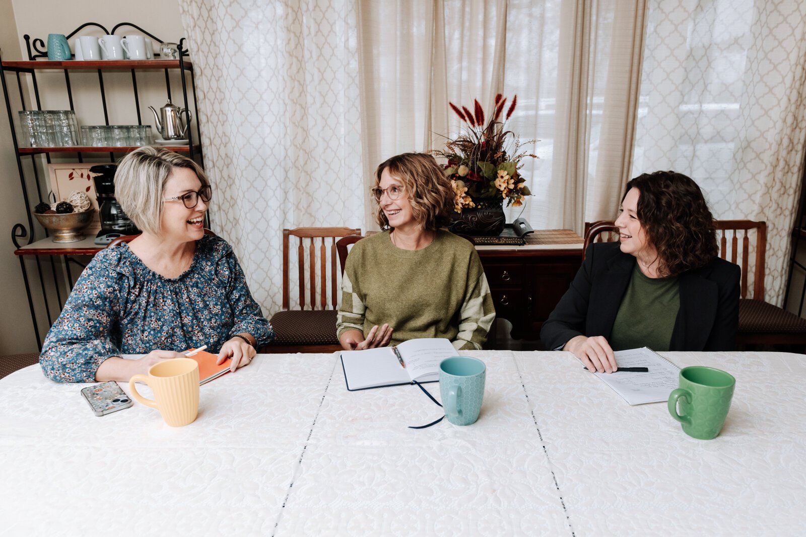  From left: Heather Morris, director of outreach and operations, Ann Heign, executive director, and Valisha Reber, medical and social services liaison chat during a staff meeting.