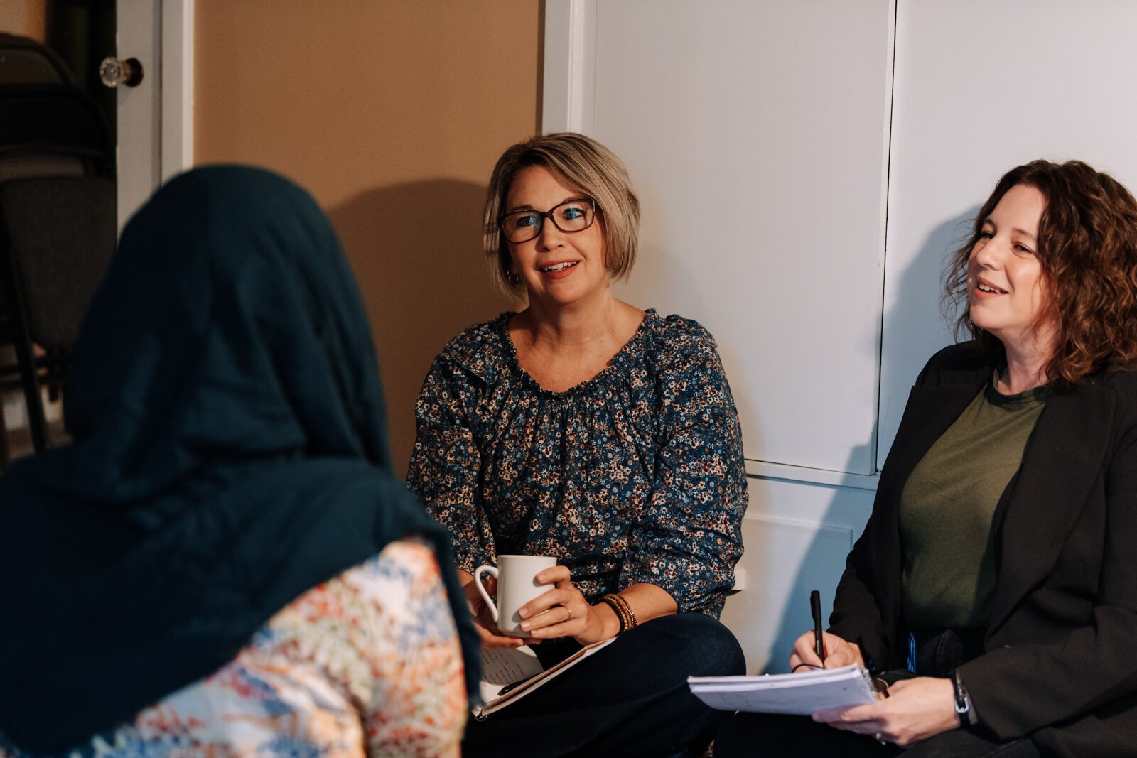 Heather Morris, director of outreach and operations, left, and Valisha Reber, medical and social services liaison demonstrate what a client in-home meeting would look like at the International House office in Fort Wayne.