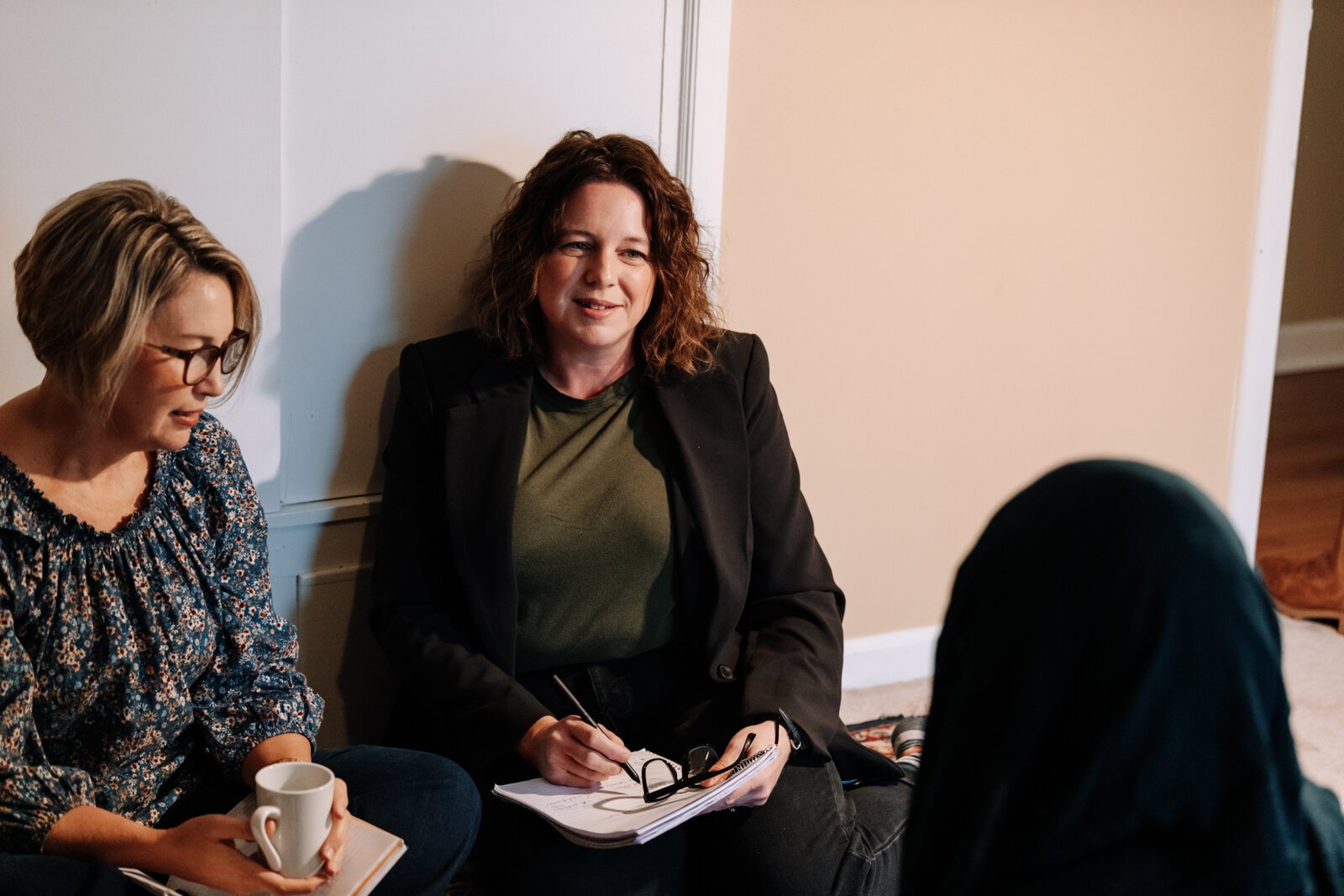 Heather Morris, director of outreach and operations, left, and Valisha Reber, medical and social services liaison demonstrate what a client in-home meeting would look like at the International House office in Fort Wayne.