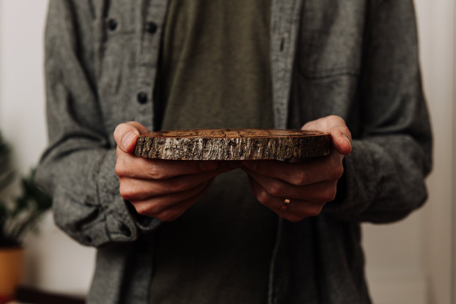 Artist James Newton holds up a piece of his pyrography.