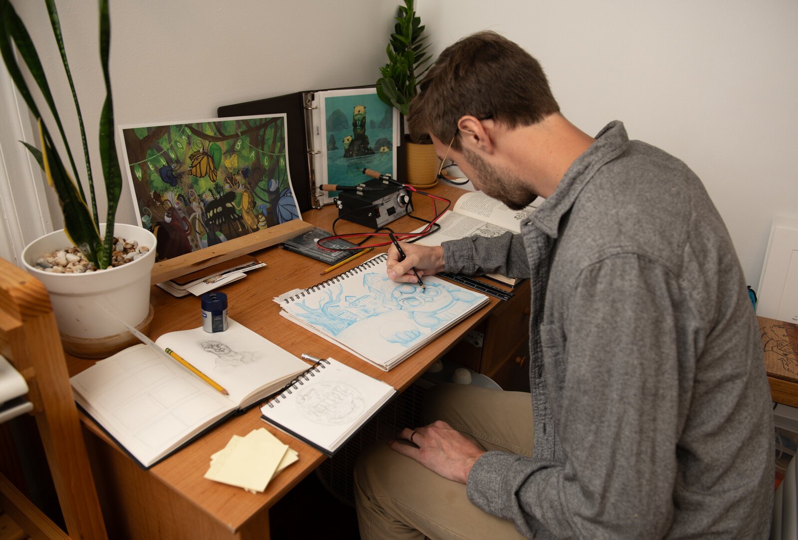 Artist James Newton works on sketching a picture book concept at his home studio in Roanoke.