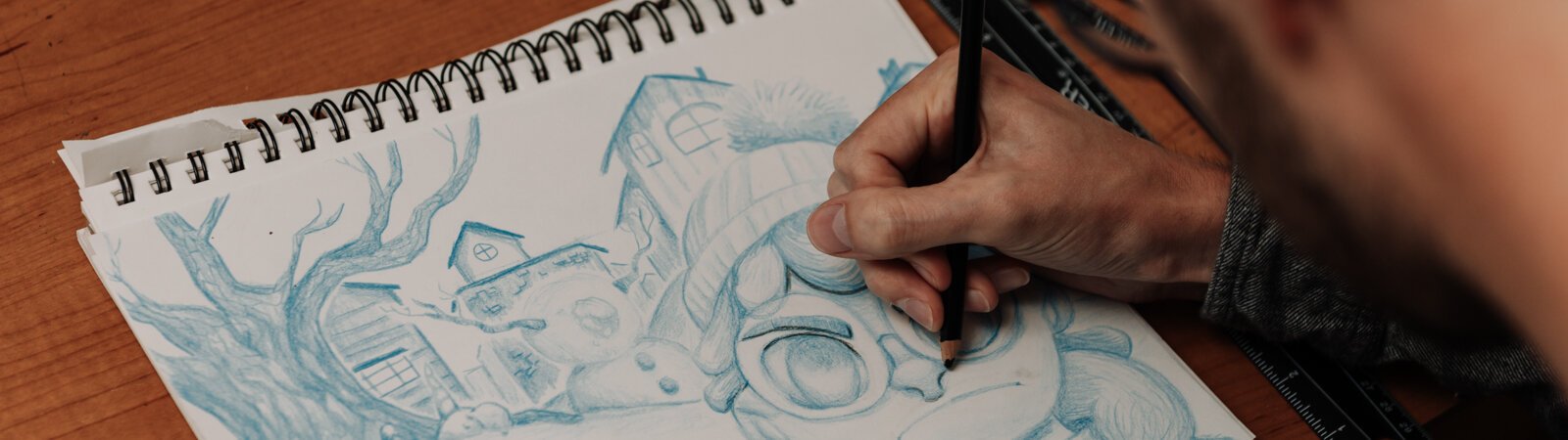 Artist James Newton works on sketching a picture book concept at his home studio in Roanoke.
