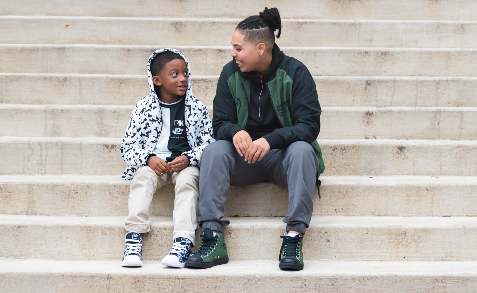 Tori Grieser, founder of Push for Progress, with Ja'Maire Frison, 7, sporting items from the Fearless and White Out Composition Collections.