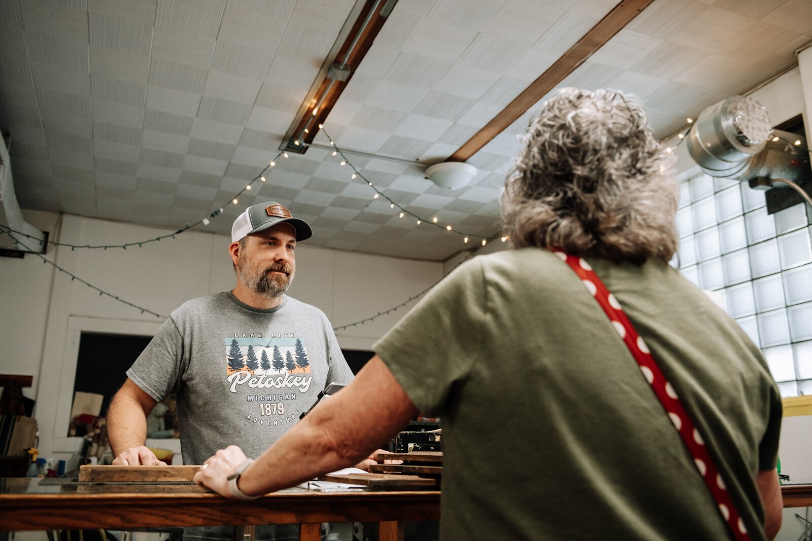 Chuck Springer helps customer Angie Cook at Reclaimed Fort Wayne.