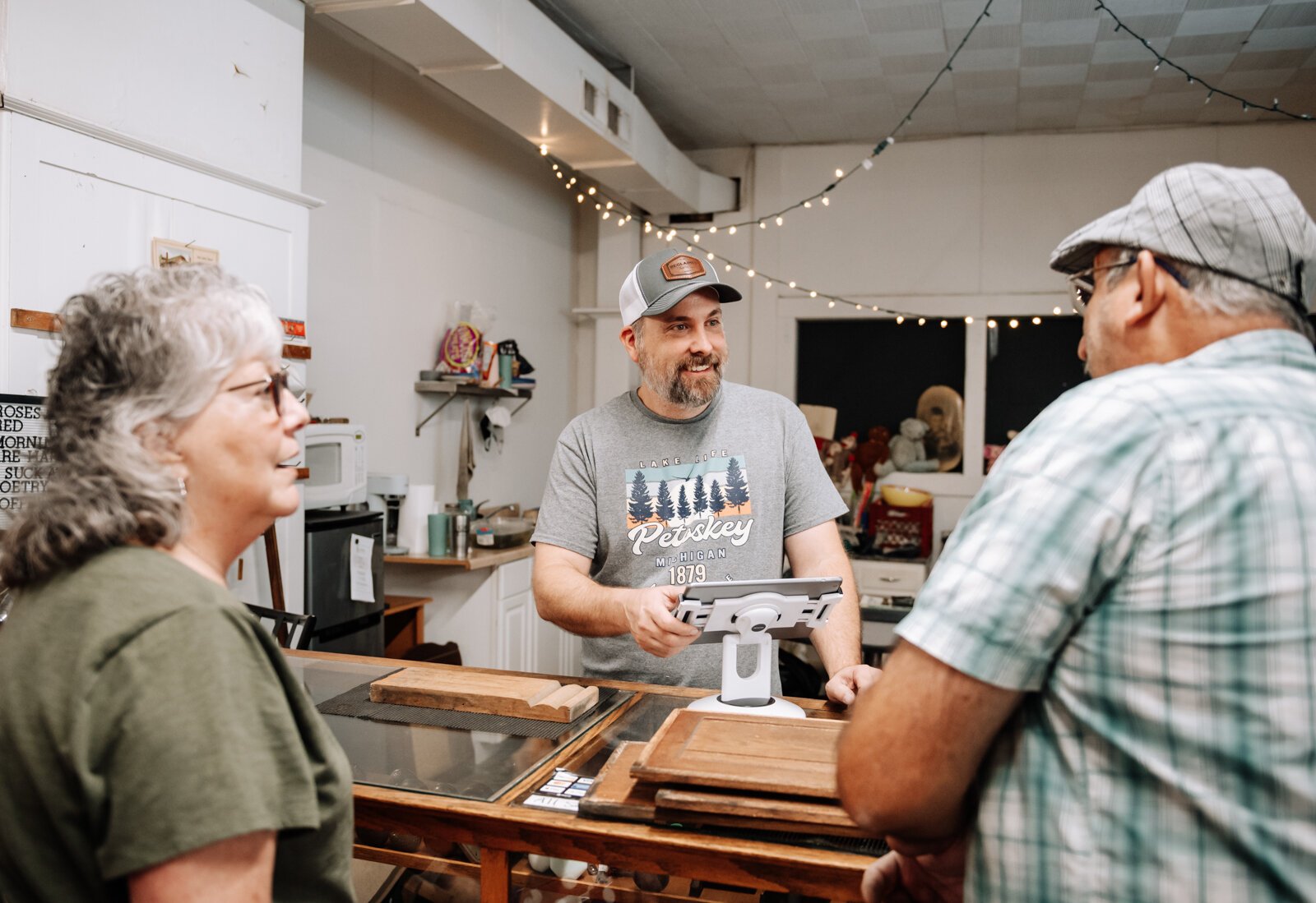 Chuck Springer helps customers Angie and Mark Cook at Reclaimed Fort Wayne.