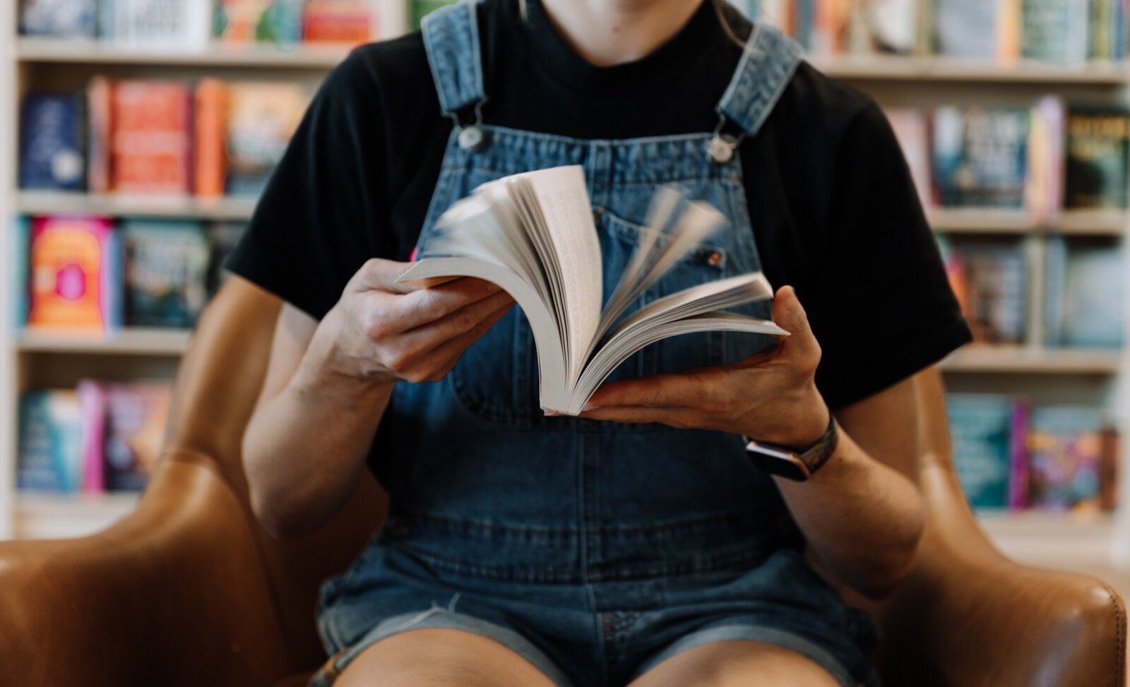 Grace Allison, employee at Sunbound Books, flips the pages of a book.