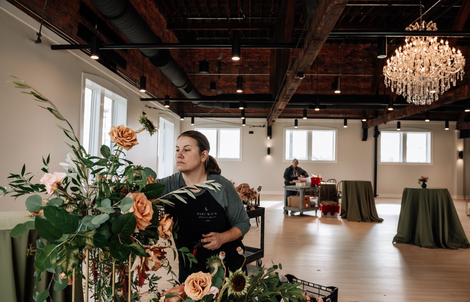 armen Fletcher with Ruby Moon Floral works on a floral installation in preparation for an upcoming wedding at The Fairfield Wedding and Events on the third floor at The Fairfield.