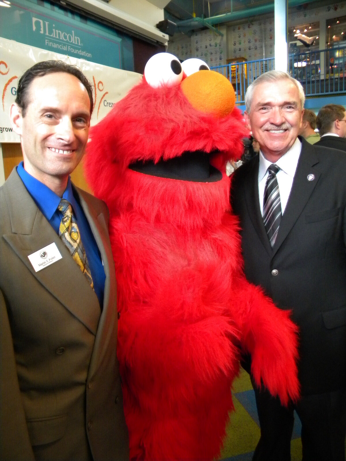 Science Central Executive Director Martin Fisher with Elmo and the late Mayor Tom Henry.