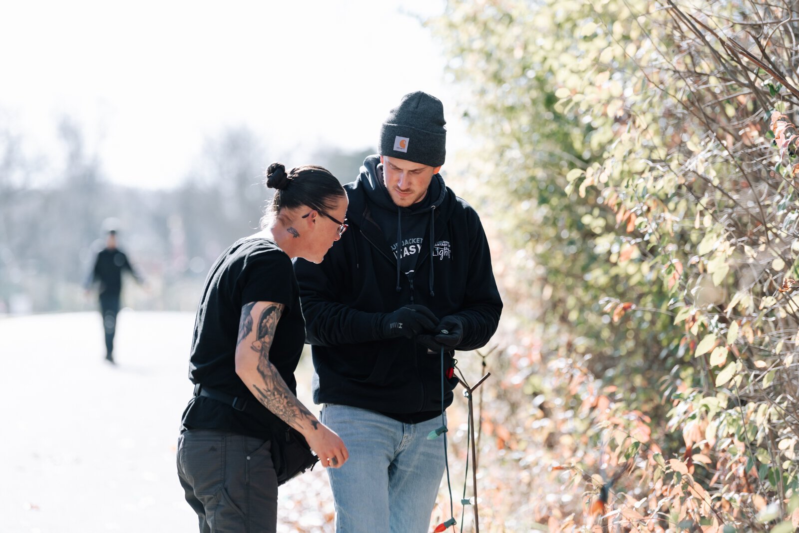 Amanda Lapham, left, and Connor West work together to set up string lights at Blue Jacket's Fantasy of Lights.