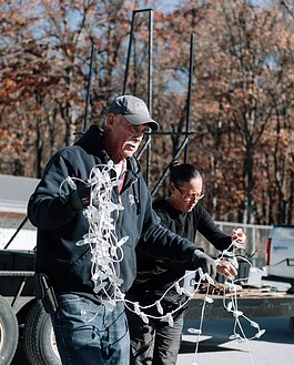 Field Team Supervisor Tom West, left, and Amanda Lapham work together to set up lights.