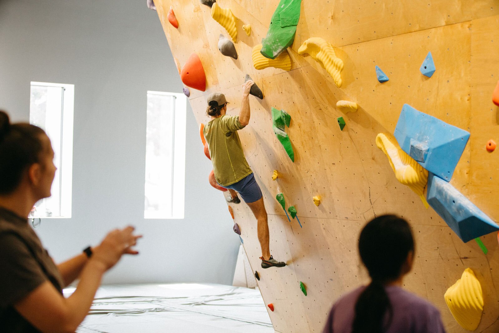 A founding member attempts a route at the soft opening of Summit City Climbing Co.