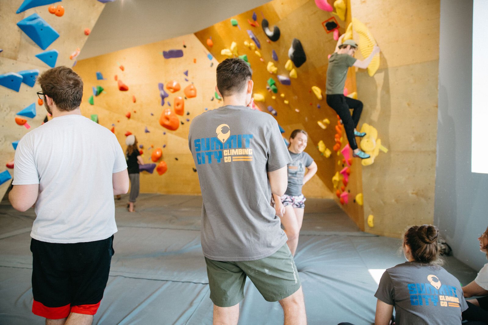 Members wait for their turn to try out the new routes at Summit City Climbing Co.