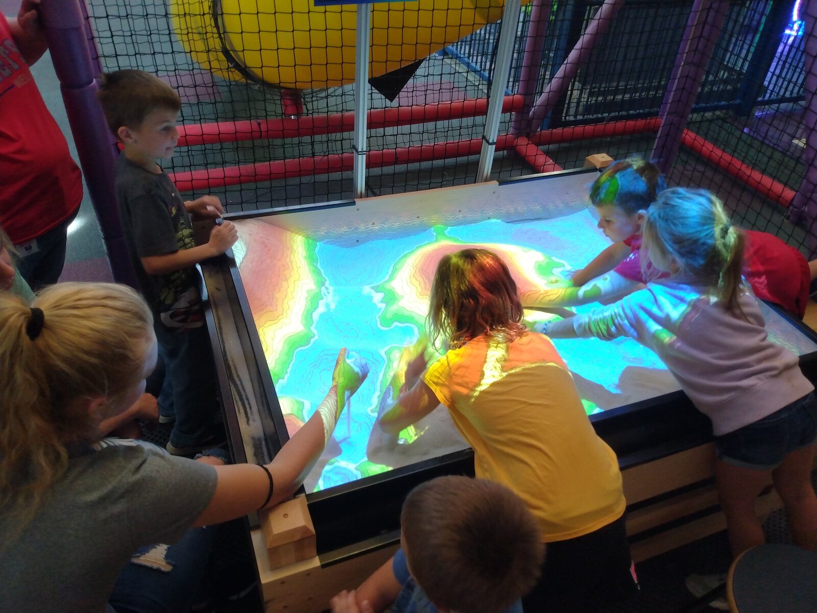 Visitors experiment with a Topo Box at Science Central.